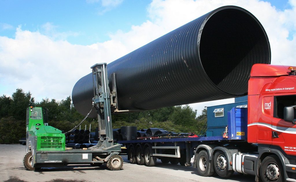 Forklift Moving an Oversized Load Onto a Truck