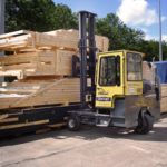 Sideloader Forklift Being Used to Move Lumber