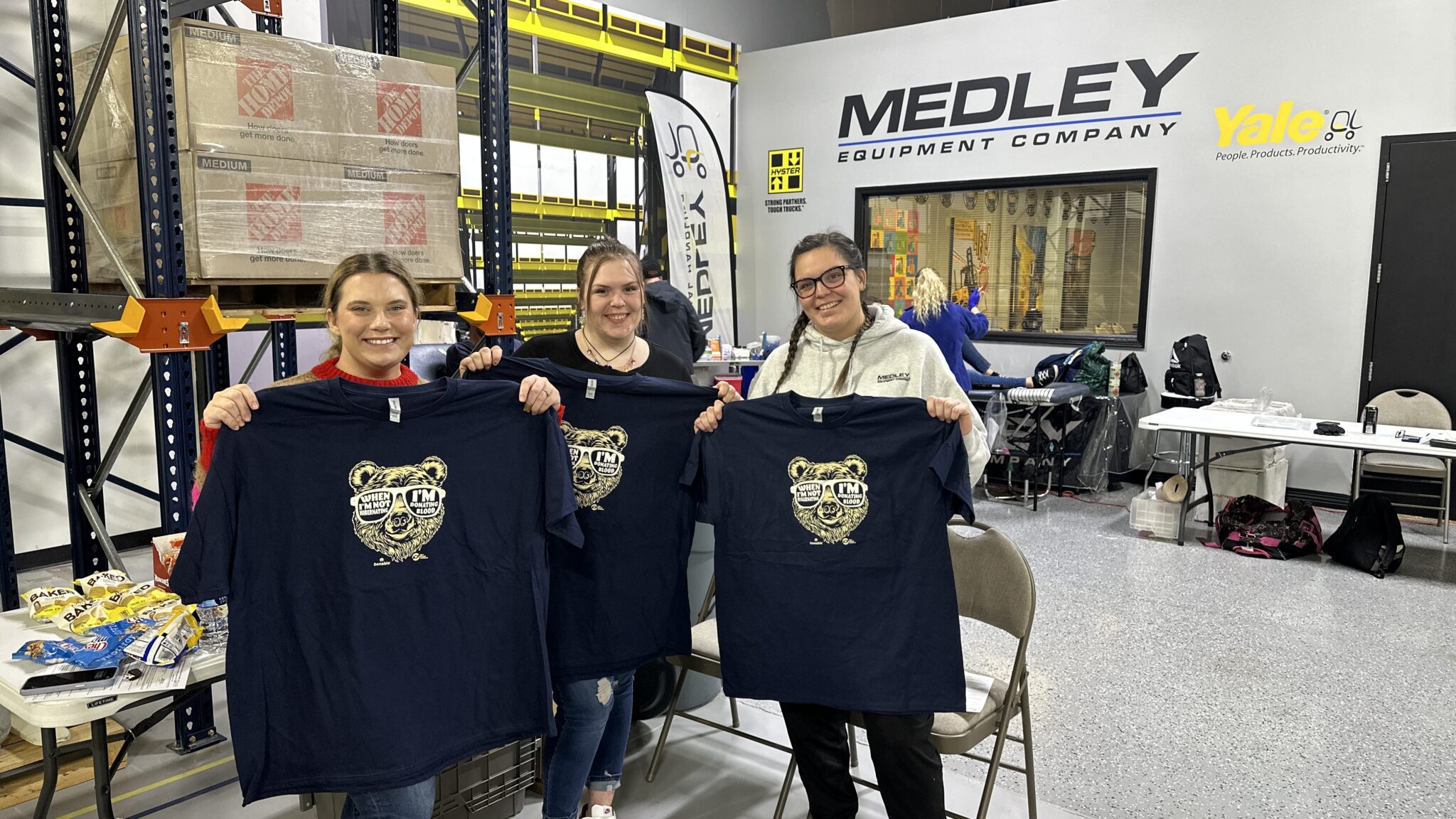 Three of our lovely Centralized Services and Sales Coordinator ladies showing off their glow in the dark Ts for their selfless donation!