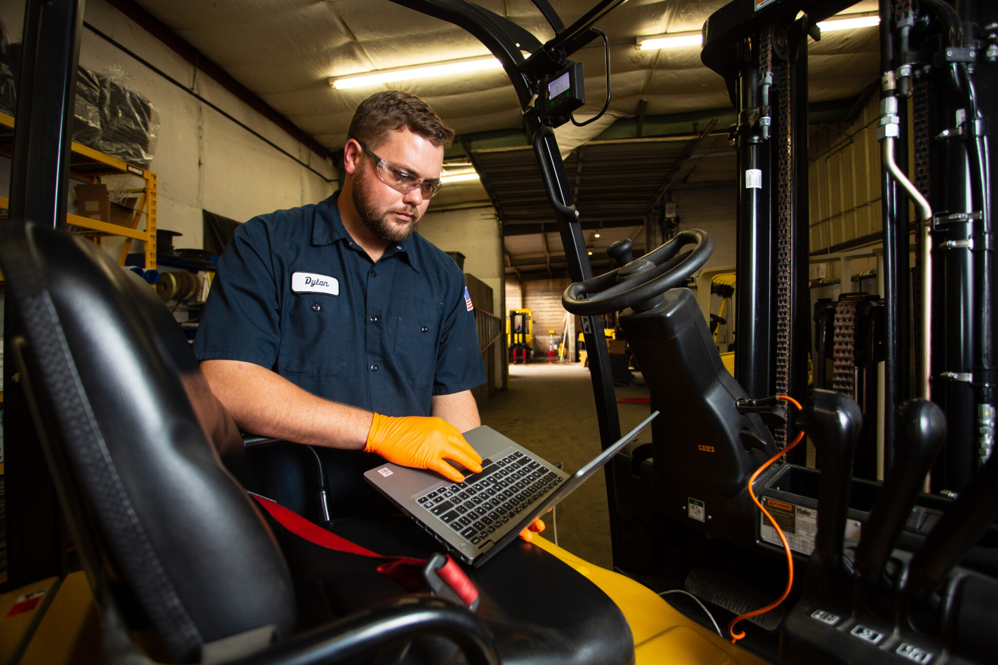 forklift technician analyzing equipment